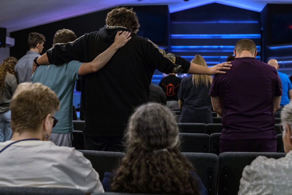 (Rubini Naidu | The New York Times) Local residents gather to mourn at the River Church in Grand Blanc Township, Mich., after the deadly shooting at a local Church of Jesus Christ of Latter-Day Saints ward on Sunday, Sept. 28, 2025. At least four people were killed after a gunman attacked the church on Sunday, the authorities said.