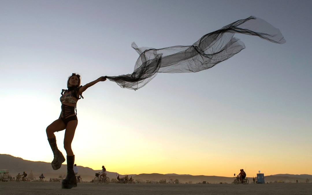 (Rick Egan  |  The Salt Lake Tribune)   Lana Mikheeda, from Russia, dances with a scarf, at Burning Man, Saturday, Aug. 31, 2019.