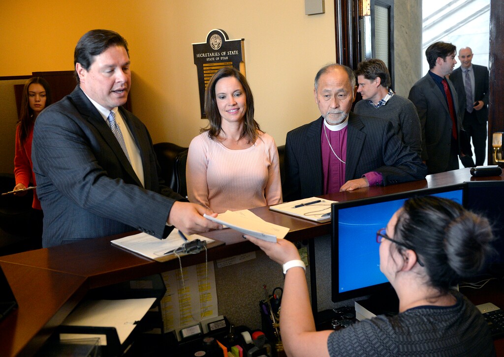 (Al Hartmann  |  The Salt Lake Tribune)  Health care advocates Alan Ormsby, with AARP Utah (left), Karina Andelin Brown, a Logan resident; and Bishop Scott Hayashi, Episcopal diocese of Utah, deliver a proposed ballot initiative to fully expand Medicaid in Utah to the Lt. Governor's office Monday Oct. 2.
