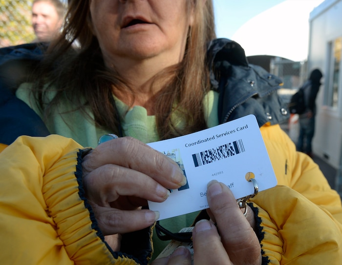 (Al Hartmann | The Salt Lake Tribune)
Homeless woman shows her coordinated services card. Starting Friday Oct. 27 officials require a homeless services ID card to access a newly created “safe space” outside the shelter accessible to people from the south on Rio Grand Street. Homeless have to have their card scanned at a booth before passing into the "safe space" which includes a large open sided tent.