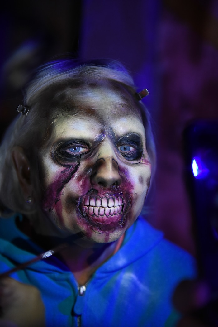 (Francisco Kjolseth  |  The Salt Lake Tribune)  State Senator Karen Mayne undergoes a drastic transformation with the help of makeup artist Jez Roberts as local politicians fall prey to the zombie apocalypse at the Fear Factory on Thursday, Oct. 12, 2017, for a special event to raise awareness of the Utah Food Bank and kick start donations. 