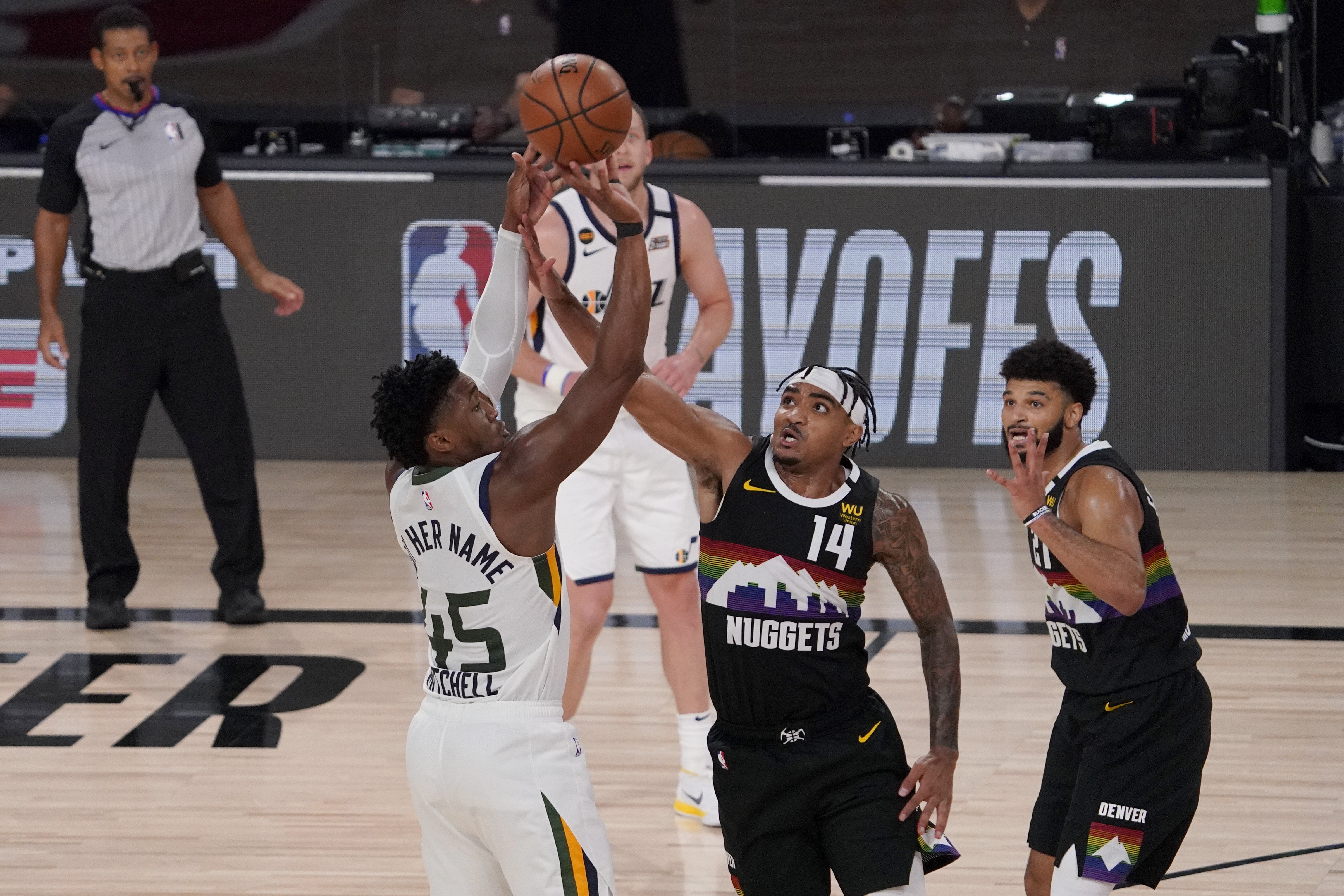 Utah Jazz's Donovan Mitchell (45) attempts a shot over Denver Nuggets' Gary Harris (14) as Jamal Murray, right, watches during the second half an NBA first round playoff basketball game, Tuesday, Sept. 1,2020, in Lake Buena Vista, Fla. (AP Photo/Mark J. Terrill)