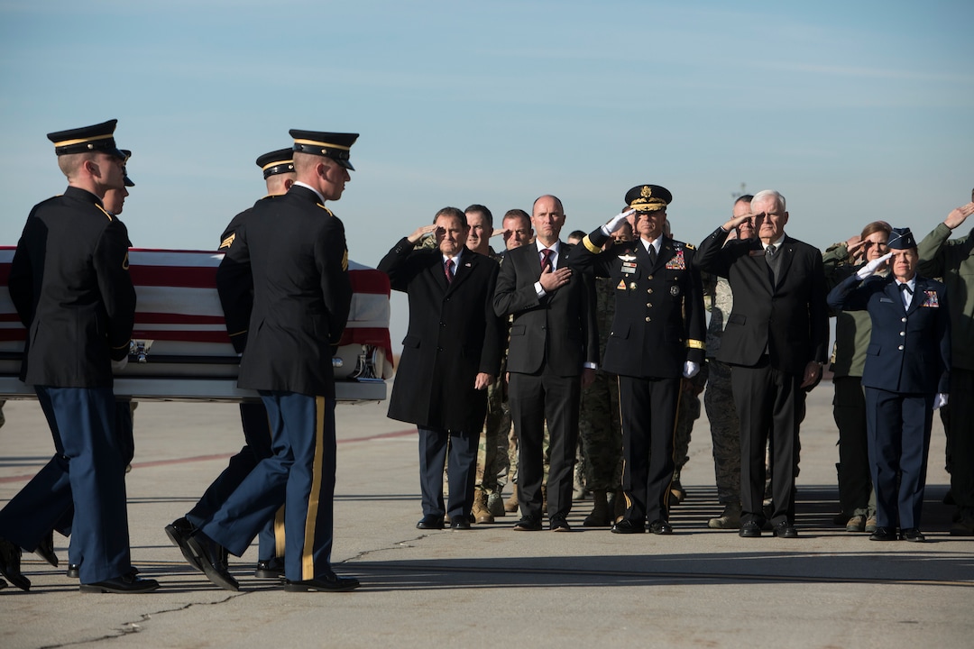 (Matt Herp  |  The Ogden Standrad Examiner/Pool) From left, Gov. Gary Herbert, Lt. Gov. Spencer J. Cox, Maj. Gen. Jefferson S. Burton, Civilian Aid to the Secretary of the Army John Edwards, and Brig. Gen. Christine Burckle salute as members of the Utah National Guard Honor Guard Detail carry a casket containing the remains of Maj. Brent R. Taylor at Roland R. Wright Air National Guard Base in Salt Lake City, Utah, on Wednesday, Nov. 14, 2018. Taylor, 39, of North Ogden, died Nov. 3, 2018, in Afghanistan of wounds sustained from small arms fire. His funeral is scheduled for Saturday, Nov. 17, in Ogden.
