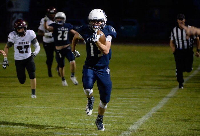 (Francisco Kjolseth  |  The Salt Lake Tribune)  Ty Burke of Syracuse runs a 77 yard touchdown in the third quarter against Jordan in game action at Syracuse on Thursday, Aug. 24, 2017.