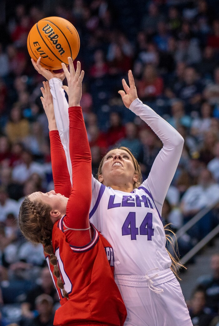 (Rick Egan | The Salt Lake Tribune) Lehi forward, Jamisyn Heaton (44) shoots, as Springville Red Devils, Kayla Porray (10) defends, in the girls 5A State Championship game between the Springville Red Devils and the Lehi Pioneers, at the Marriott Center in Provo, on Saturday, March 5, 2022. 
