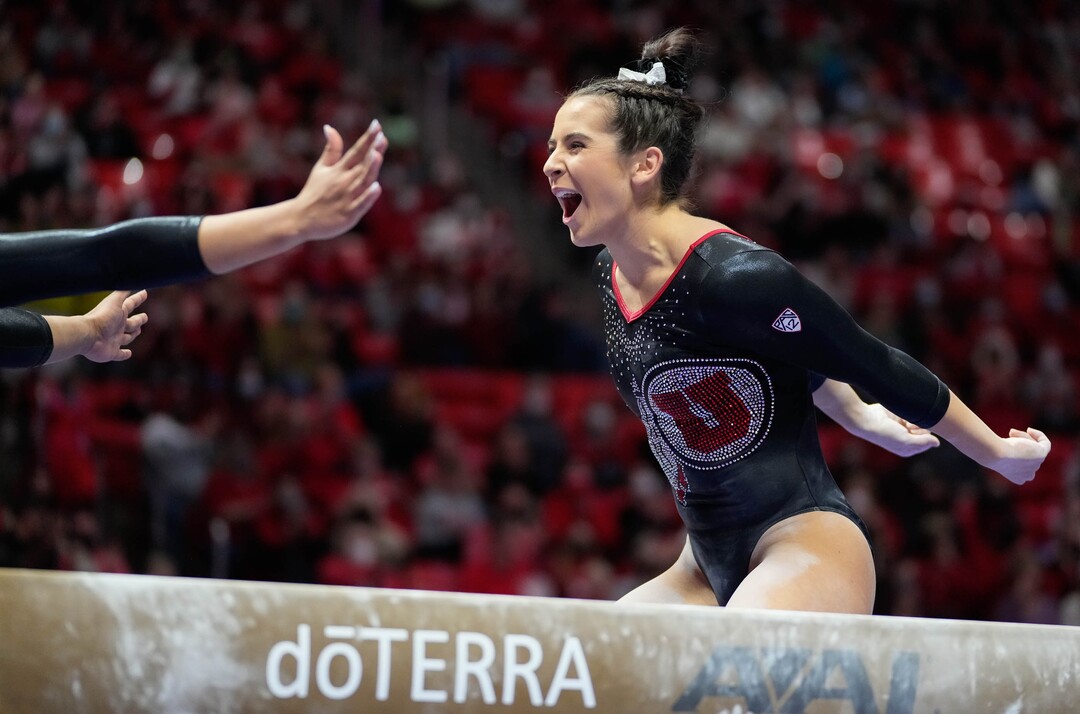 (Francisco Kjolseth | The Salt Lake Tribune) Utah’s Alexia Burch is celebrates by teammates following an exhibition routine on beam during their gymnastics meet with Stanford at the Huntsman Center in Salt Lake City, Saturday, Jan. 29, 2022.