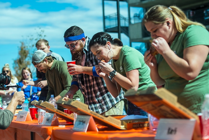 (Chris Detrick | The Salt Lake Tribune) Employees compete in a pizza eating competition during a fundraiser for United Way at CHG Healthcare Wednesday, September 20, 2017.