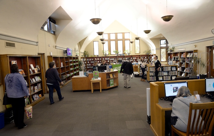 (Al Hartmann | The Salt Lake Tribune)
People trickle in to the re-opened Sprague Library on Monday, Oct. 23. It's offering limited services after its basement flooded in July. The main floor of the English Tudor-style building has been rearranged. The basement, which housed non-fiction, children's books, and community meeting rooms, will remain closed for some time.