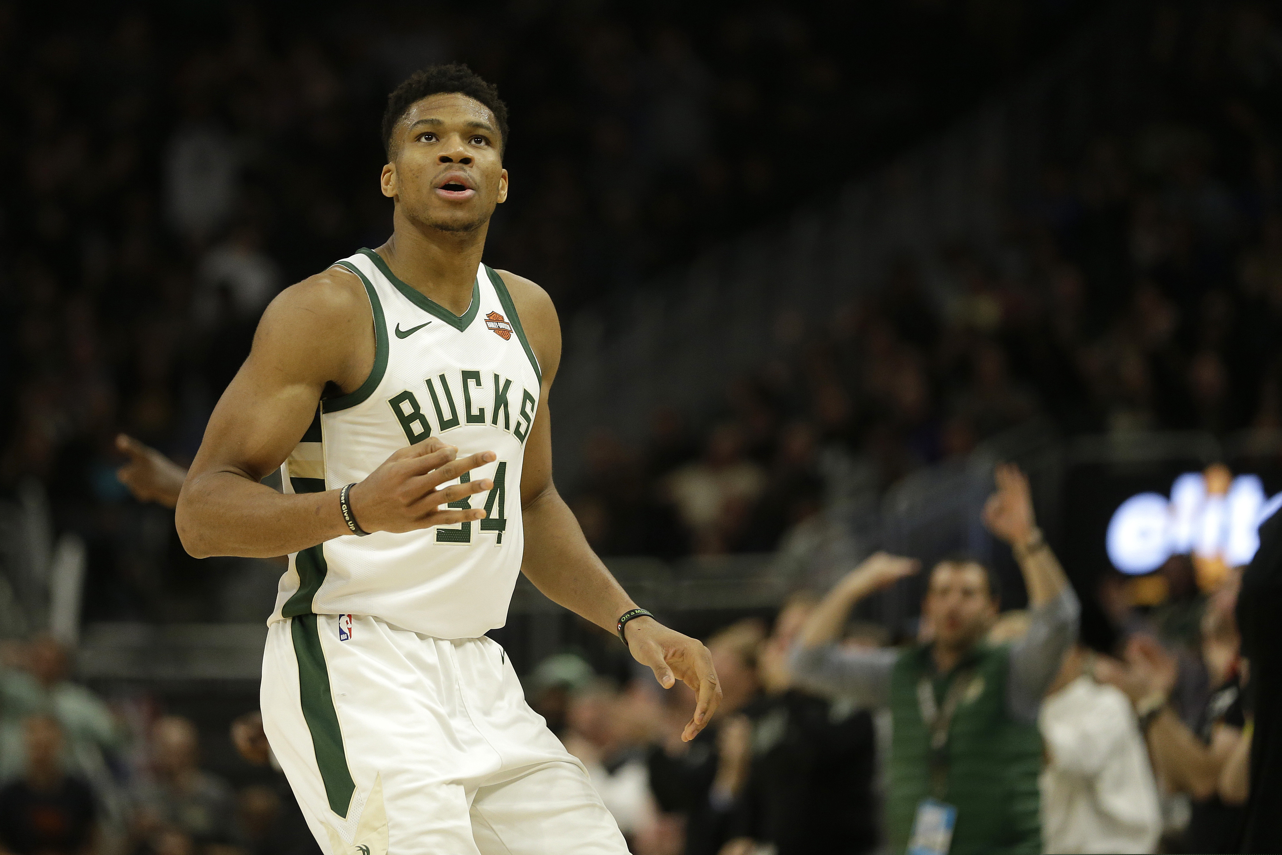 Milwaukee Bucks' Giannis Antetokounmpo reacts after making a 3-pointer during the second half of an NBA basketball game against the Utah Jazz Monday, Nov. 25, 2019, in Milwaukee. (AP Photo/Aaron Gash)