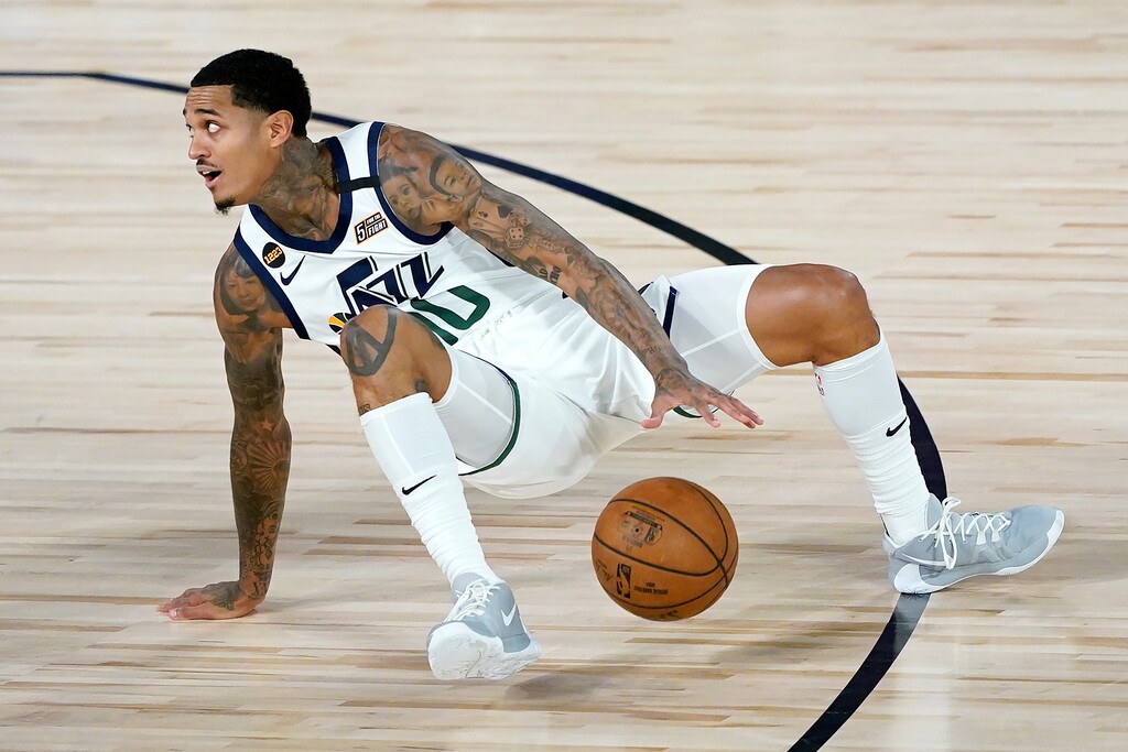 (Ashley Landis | AP) Utah Jazz's Jordan Clarkson (00) dribbles while trying to stay upright during the first half of an NBA basketball first round playoff game against the Denver Nuggets, Monday, Aug. 17, 2020, in Lake Buena Vista, Fla.