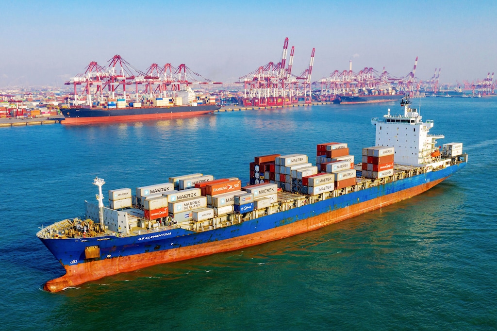 A container vessel moves past the port in Qingdao in eastern China's Shandong province on Tuesday, Jan. 14, 2020. China's exports rose 0.5% in 2019 despite a tariff war with Washington after growth rebounded in December on stronger demand from other markets. (Chinatopix Via AP)