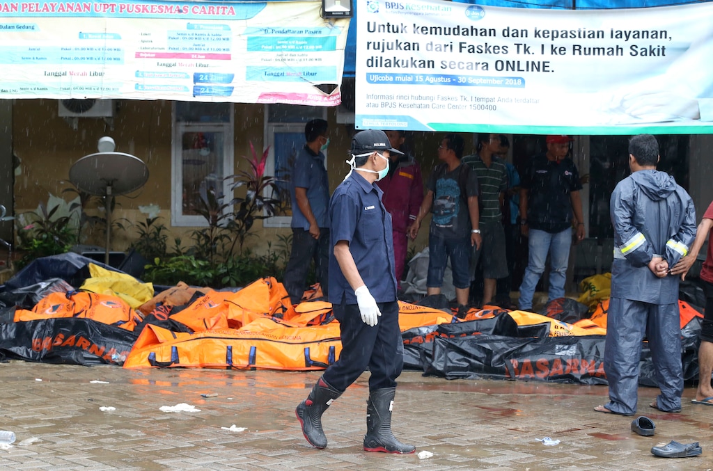(Achmad Ibrahim | The Associated Press) Wrapped bodies of tsunami victims are laid in Carita, Indonesia, Sunday, Dec. 23, 2018. The tsunami occurred after the eruption of a volcano around Indonesia's Sunda Strait during a busy holiday weekend, sending water crashing ashore and sweeping away hotels, hundreds of houses and people attending a beach concert.