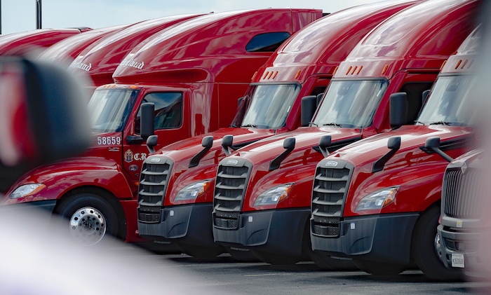 (Francisco Kjolseth | The Salt Lake Tribune) Trucks come and go at C.R. England trucking in Salt Lake City on Monday, March 30, 2020. The coronavirus outbreak has helped make truckers heroes as they help to stock empty shelves in stores. Drivers face new challenges from finding restrooms and food on the road amid shutdowns, but say they enjoy driving with no congestion.