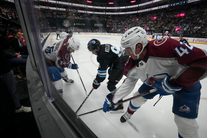 (Bethany Baker | The Salt Lake Tribune) Utah Hockey Club center Clayton Keller (9) vies for the puck with Colorado Avalanche defenseman Josh Manson (42) and Colorado Avalanche center Matt Stienburg (36) during the game between the Utah Hockey Club and the Colorado Avalanche at the Delta Center in Salt Lake City on Thursday, Oct. 24, 2024.