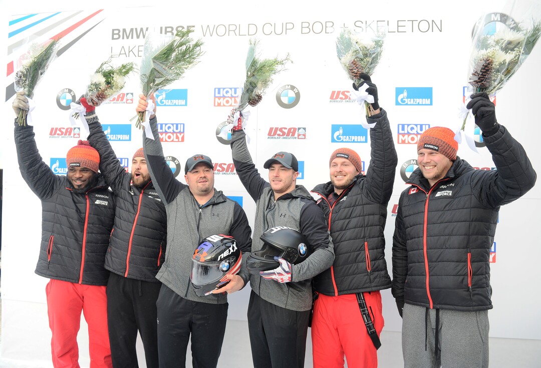 First-place winners, center, Steven Holcomb and Carlo Valdes, of the United States; second-place winners, left, Justin Kripps and Jesse Lumsden, of Canada; and third-place finishers, right, Chris Spring and Lascelles Brown, also of Canada, celebrate in the finish area after the men's two-man bobsled World Cup race on Friday, Dec. 16, 2016, in Lake Placid, N.Y. (AP Photo/Hans Pennink)