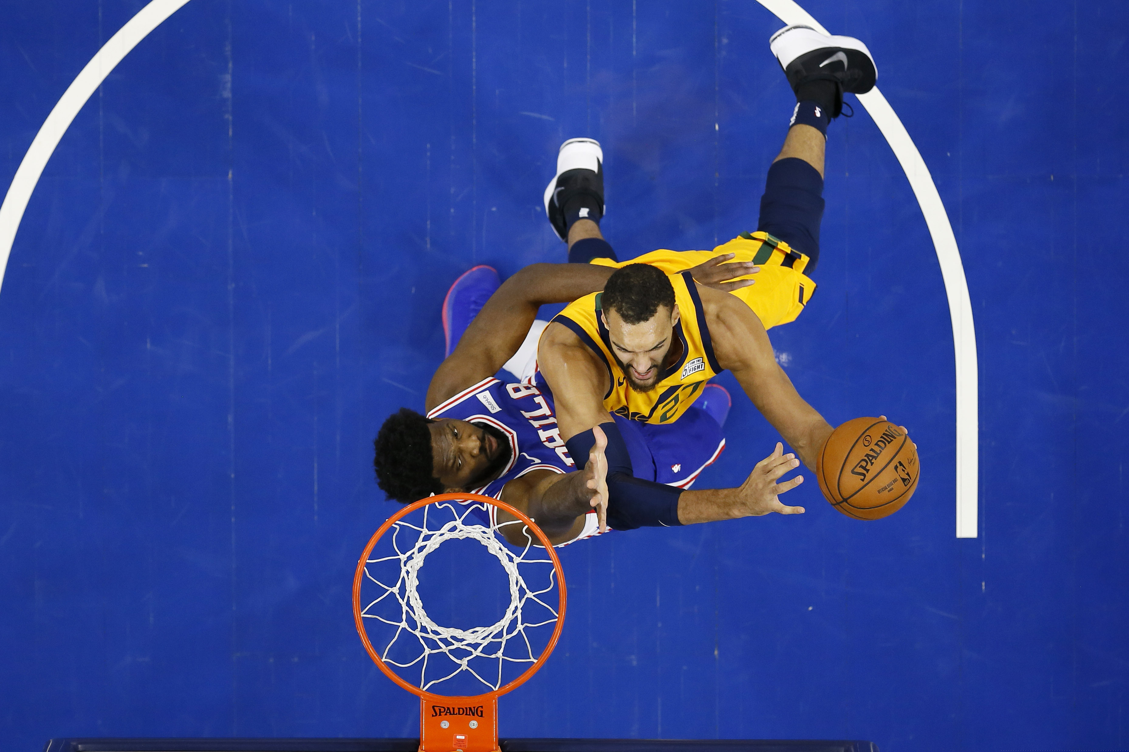 Utah Jazz's Rudy Gobert, right, goes up to shoot against Philadelphia 76ers' Joel Embiid during the first half of an NBA basketball game, Monday, Dec. 2, 2019, in Philadelphia. (AP Photo/Matt Slocum)