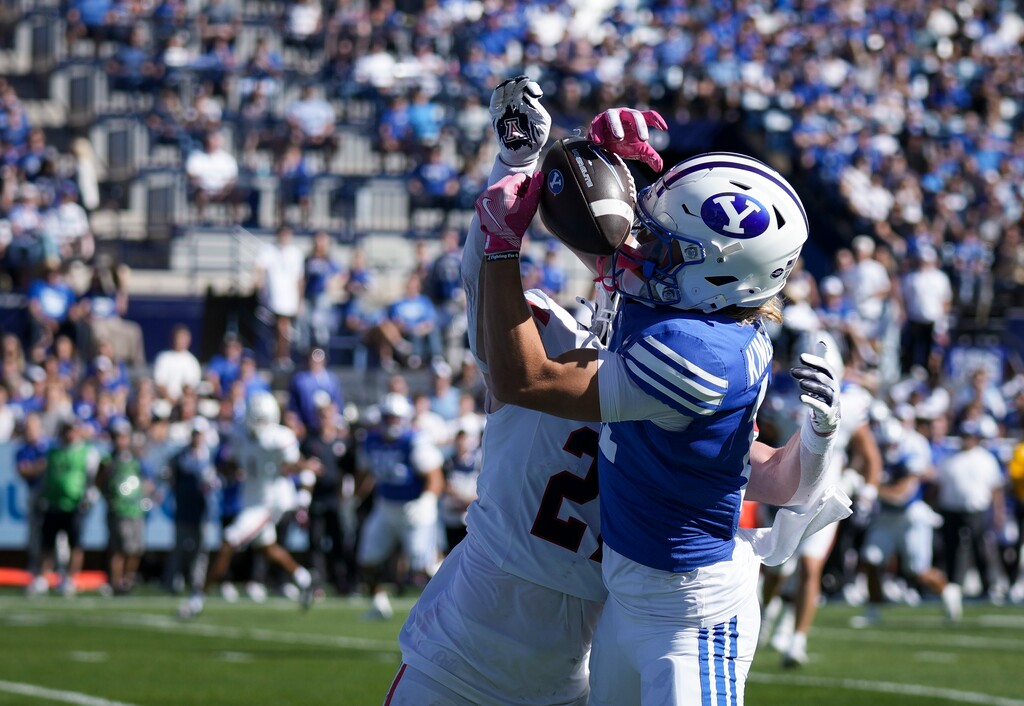 (Bethany Baker | The Salt Lake Tribune) Brigham Young Cougars wide receiver Parker Kingston (11) catches a pass before scoring a touchdown as he is defended by Arizona Wildcats defensive back Owen Goss (27) during the game between the Brigham Young Cougars and the Arizona Wildcats in Provo on Saturday, Oct. 12, 2024.