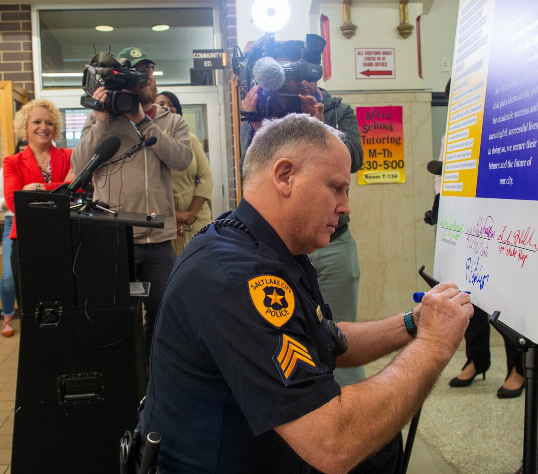 (Rick Egan  |  The Salt Lake Tribune)       Salt Lake City Police SRO Sgt. Phil Eslinger signs the school resource officer contract at West High School, Tuesday, March 26, 2019.
