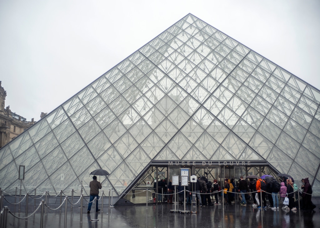 (Rafael Yaghobzadeh | The Associated Press) Tourists stand outside the Louvre museum, in Paris, France, Sunday, March 1, 2020. The spreading coronavirus epidemic shut down France's Louvre Museum on Sunday, with workers who guard its trove of artworks fearful of being contaminated by the museum's flow of visitors from around the world.