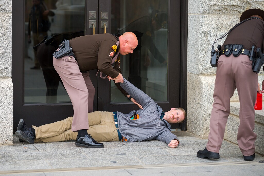 (Trent Nelson  |  The Salt Lake Tribune) Bobby Kennedy is handcuffed after blocking an entrance at the State Capitol as the Utah Legislature hold a special session in Salt Lake City on Tuesday, Nov. 9, 2021. Kennedy expressed his disgust at the redistricting maps put out by the Legislature and said, "I've never done anything like this. This is a decade of misrepresentation."