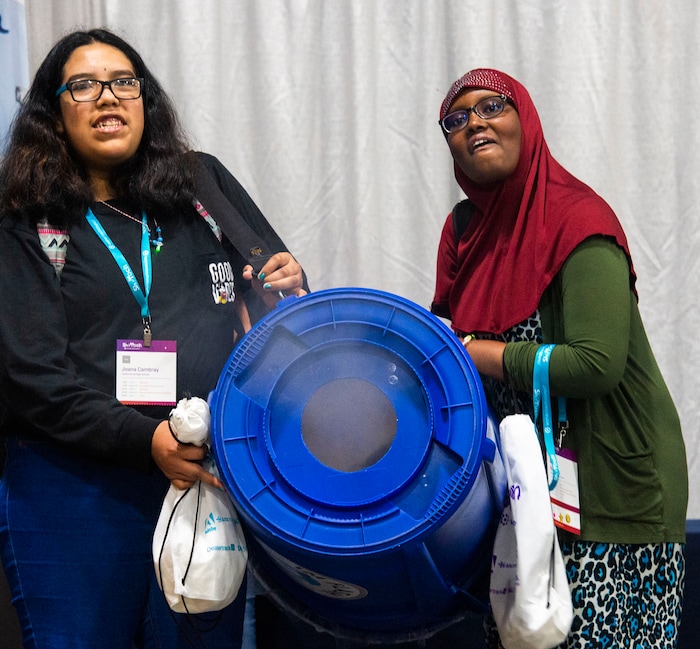 (Rick Egan  |  The Salt Lake Tribune)         Alejendra Arias and Munira Abdi make smoke rings, at the SheTech Explorer Day event, at the Mountain America Expo Center in Sandy, Tuesday, April 9, 2019.
