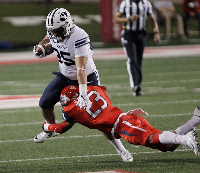 BYU's Brayden El-Bakri runs past Fresno State's Juju Hughes during the first half of an NCAA college football game in Fresno, Calif., Saturday, Nov. 4, 2017. (AP Photo/Gary Kazanjian)