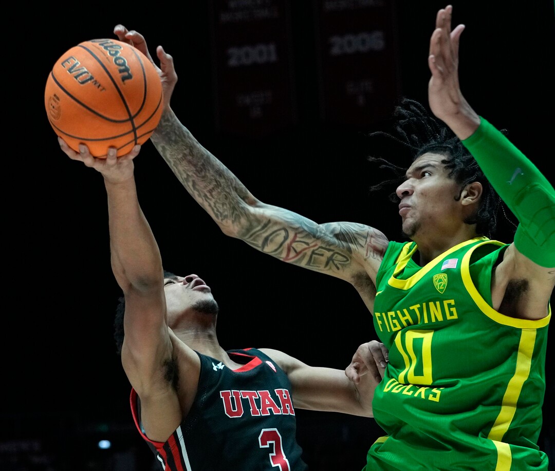 (Leah Hogsten | The Salt Lake Tribune) Utah Utes forward Bostyn Holt (3) is blocked by Oregon Ducks center Kel'el Ware (10) as the University of Utah hosts Oregon at the Huntsman Center, Jan. 7, 2023.
