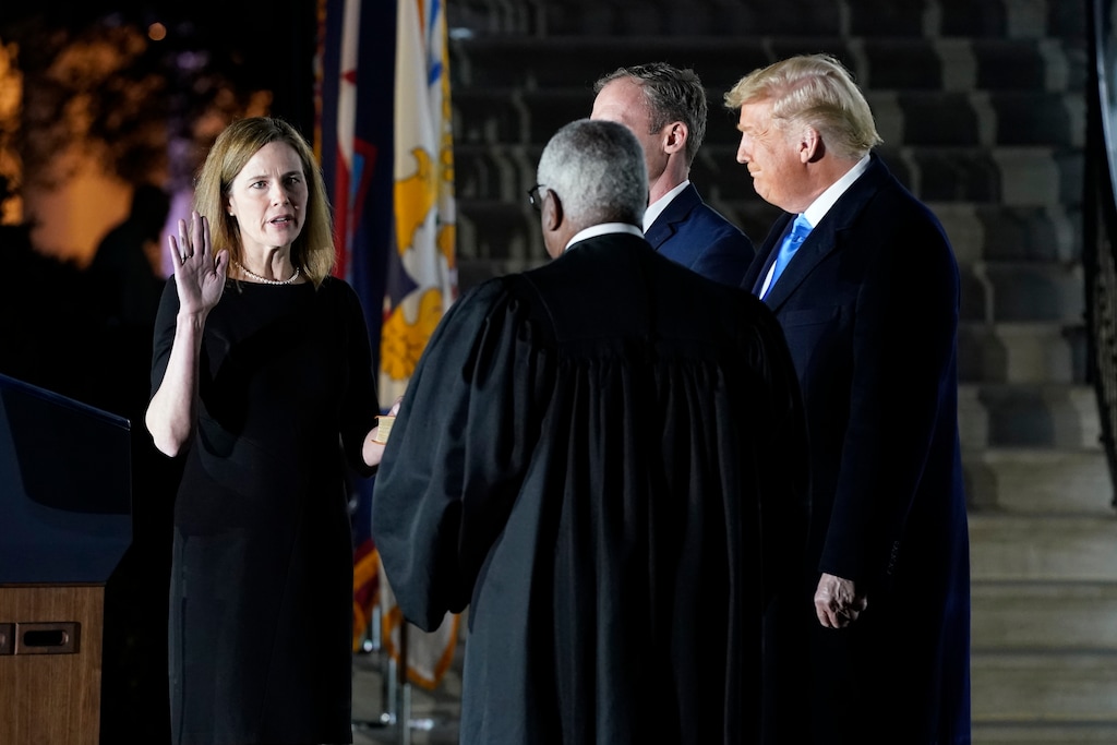 (Patrick Semansky | AP) President Donald Trump watches as Supreme Court Justice Clarence Thomas administers the Constitutional Oath to Amy Coney Barrett on the South Lawn of the White House in Washington, Monday, Oct. 26, 2020, after Barrett was confirmed by the Senate earlier in the evening.