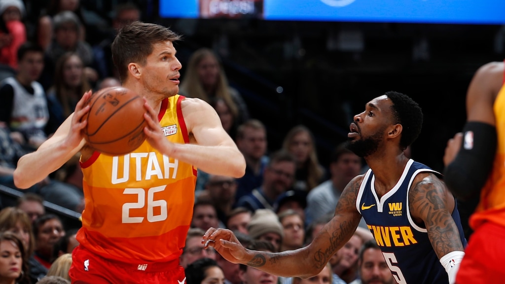 Utah Jazz guard Kyle Korver, left, looks to pass the ball as Denver Nuggets guard Will Barton defends during the first half of an NBA basketball game Thursday, Feb. 28, 2019, in Denver. (AP Photo/David Zalubowski)