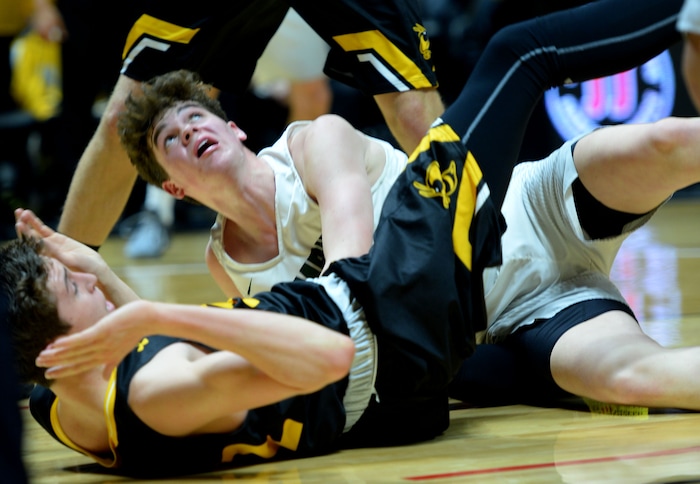 Steve Griffin | The Salt Lake Tribune
Olympus guard Jeremy DowDell looks up to see if his shot went in after crashing into Wasatch guard Brandon Maxwell during 4A playoff game at the Huntsman Center in Salt Lake City Tuesday February 28, 2017.