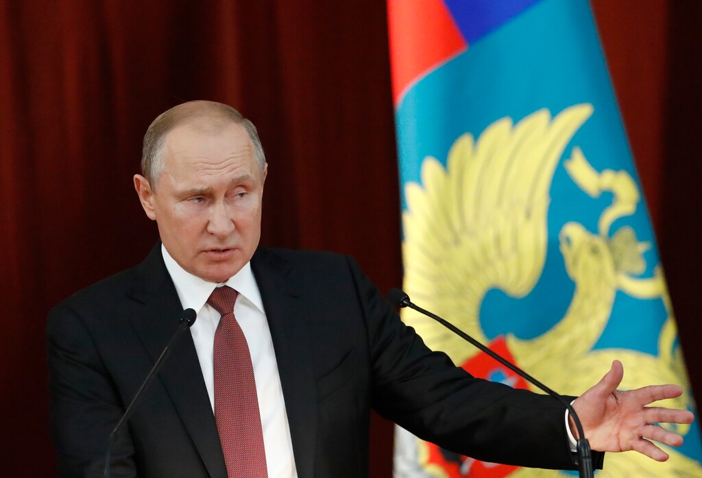 Russian Vladimir Putin gestures during a meeting with Russian ambassadors to foreign countries in Moscow, Russia, Thursday, July 19, 2018. Putin says his first summit with U.S. President Donald Trump was "successful" and is accusing Trump's opponents in the U.S. of hampering any progress on the issues they discussed. (Sergei Karpukhin/Pool Photo via AP)