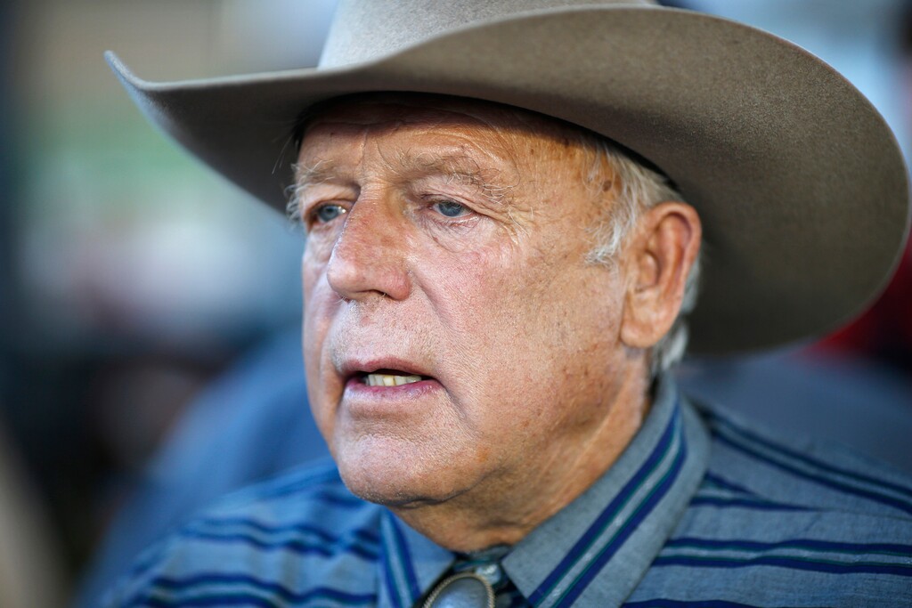 FILE - In this April 11, 2015, file photo, Nevada rancher Cliven Bundy speaks with supporters at an event in Bunkerville, Nev. A federal judge in Nevada is considering crucial rulings about what jurors will hear in the trial of six defendants accused of stopping U.S. agents at gunpoint from rounding up cattle near Cliven Bundy's ranch in April 2014. (AP Photo/John Locher, File)