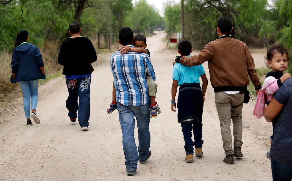 (Eric Gay | The Associated Press) In this March 14, 2019, file photo, a group of migrant families walk from the Rio Grande, the river separating the U.S. and Mexico in Texas, near McAllen, Texas, right before being apprehended by Border Patrol. U.S. border authorities say they’ve started to increase the biometric data they take from children 13 years of age and younger, including fingerprints, despite privacy concerns and government policy intended to restrict what can be collected from migrant youth.