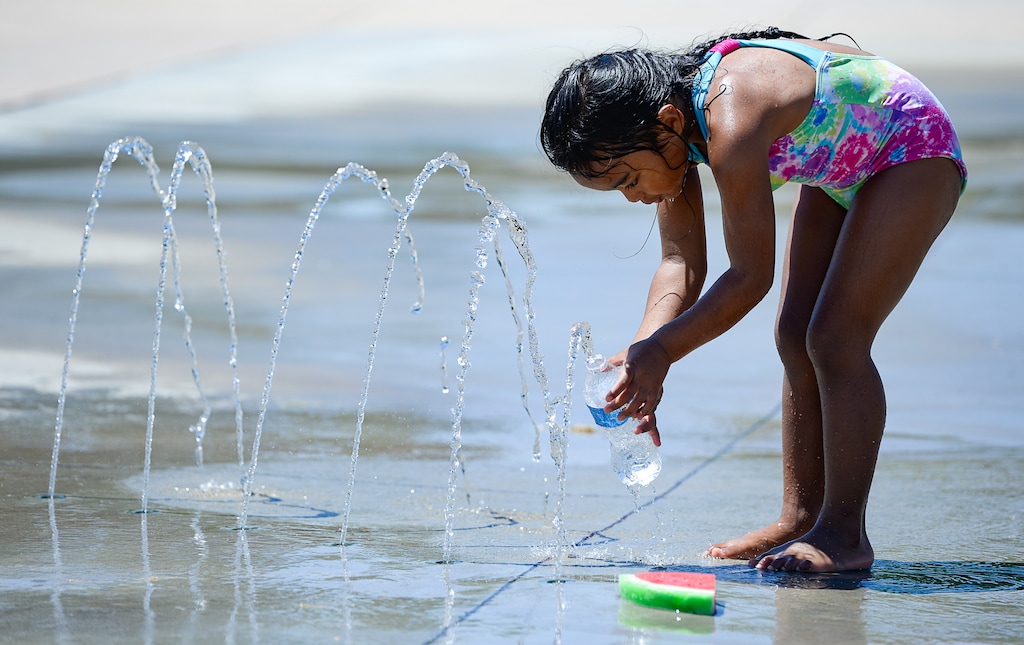 (Francisco Kjolseth | Tribune file photo) A child plays in the water as kids cool off at Mountain View Park in Cottonwood Heights. Utah’s water conservation goals got a big makeover this week with the release of a revised plan for reducing municipal water use.
