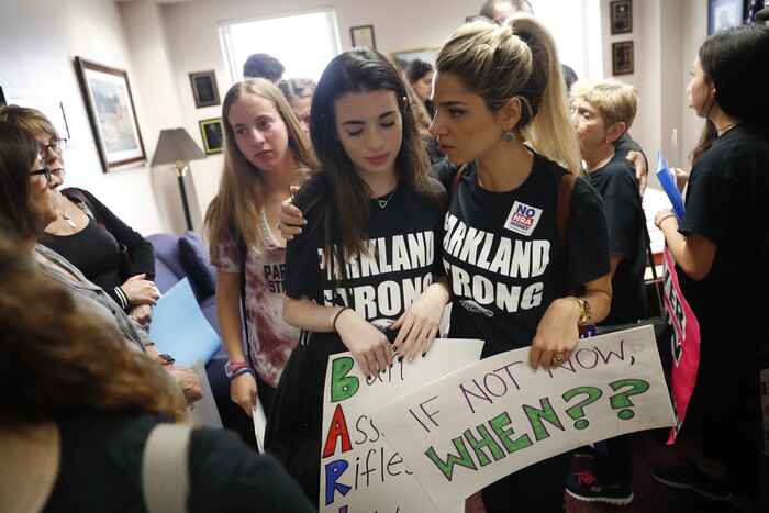 Lital Donner, youth director for Congregation Kol Tikvah, comforts Aria Siccone, 14, a 9th grade student survivor from Marjory Stoneman Douglas High School, where over a dozen were killed in a mass shooting on Wednesday, after Aria told her story of that day to a legislator, as they challenge lawmakers in the state capitol on gun control reform, in Tallahassee, Fla., Wednesday, Feb. 21, 2018. (AP Photo/Gerald Herbert)