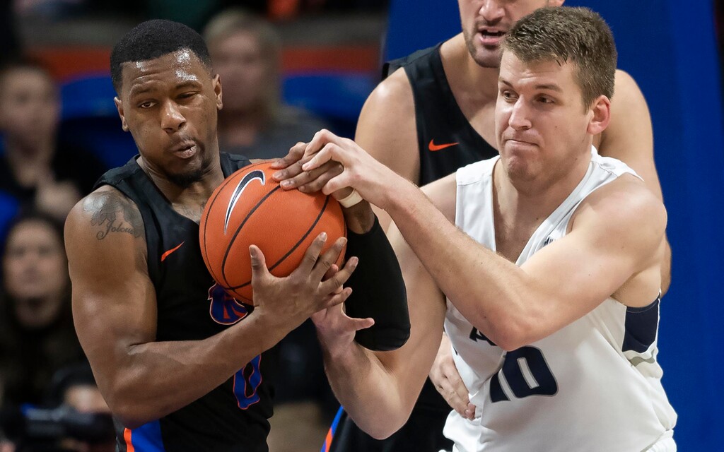 Boise State guard Marcus Dickinson forces a jump ball call while attempting a steal from Utah State's Quinn Taylor during the first half of an NCAA college basketball game Saturday, Feb. 23, 2019, in Boise, Idaho. (Darin Oswald/Idaho Statesman via AP)