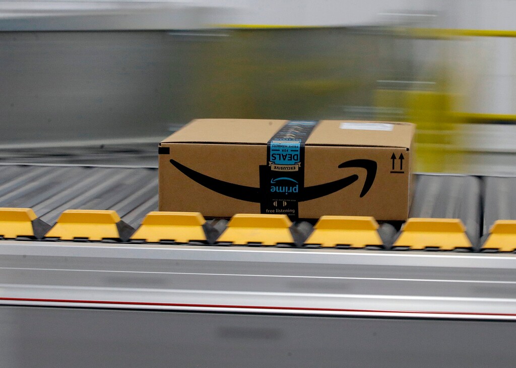 (AP Photo/Rich Pedroncelli) In this Feb. 9, 2018, file photo, a box for an Amazon prime customer moves through the new Amazon Fulfillment Center in Sacramento, Calif.