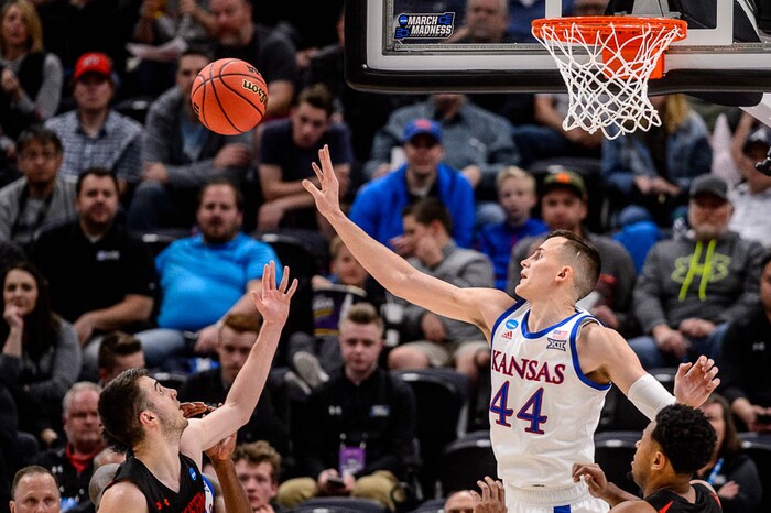 (Trent Nelson | The Salt Lake Tribune)  
Kansas Jayhawks forward Mitch Lightfoot (44) blocks a shot by Northeastern Huskies guard Vasa Pusica (4) as Kansas faces Northeastern in the 2019 NCAA Tournament in Salt Lake City on Thursday March 21, 2019.