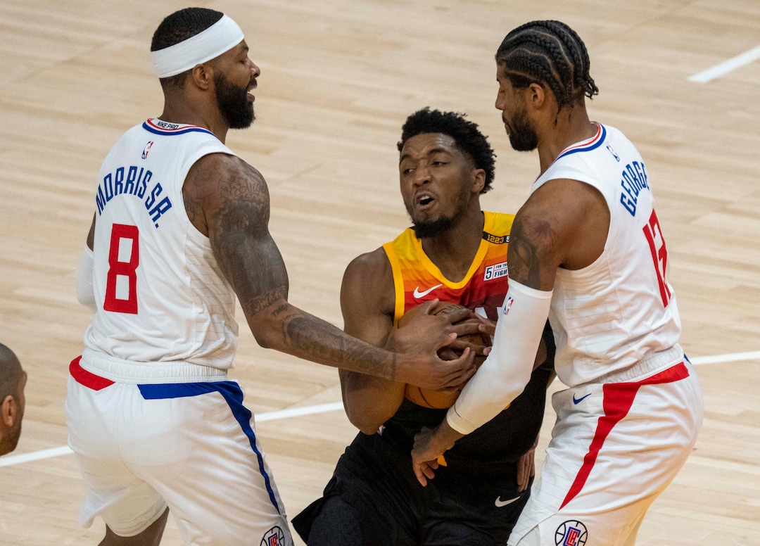 (Rick Egan | The Salt Lake Tribune) Utah Jazz guard Donovan Mitchell (45) is stopped by LA Clippers forward Marcus Morris Sr. (8) and LA Clippers guard Paul George (13), in second round playoff action in game 2 between the Utah Jazz and the LA Clippers, at Vivint Arena, on Thursday, June 10, 2021.