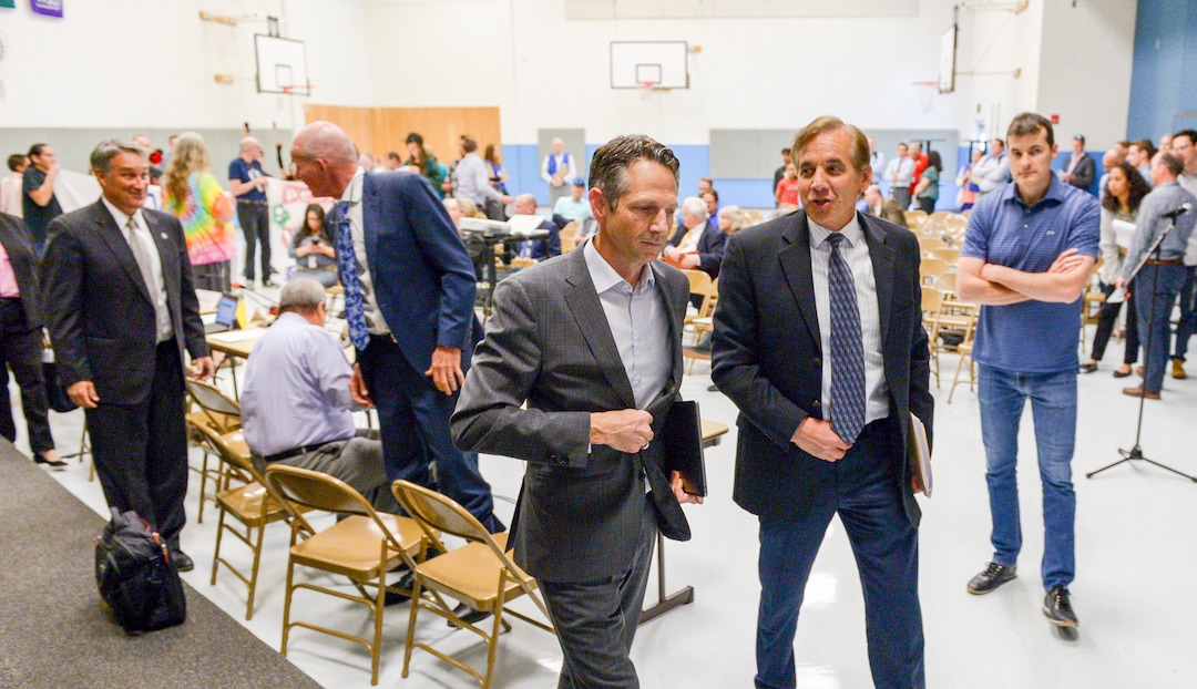 Leah Hogsten  |  The Salt Lake Tribune   Derek Miller (center) leaves the meeting and canceled the meeting shortly after leaving the gymnasium. A group called Civil Riot shut down the Inland Port Authority Board meeting at North Star Elementary's gymnasium Wednesday, April 24, 2019 shortly after it began by speaking over board chairman Derek Miller.