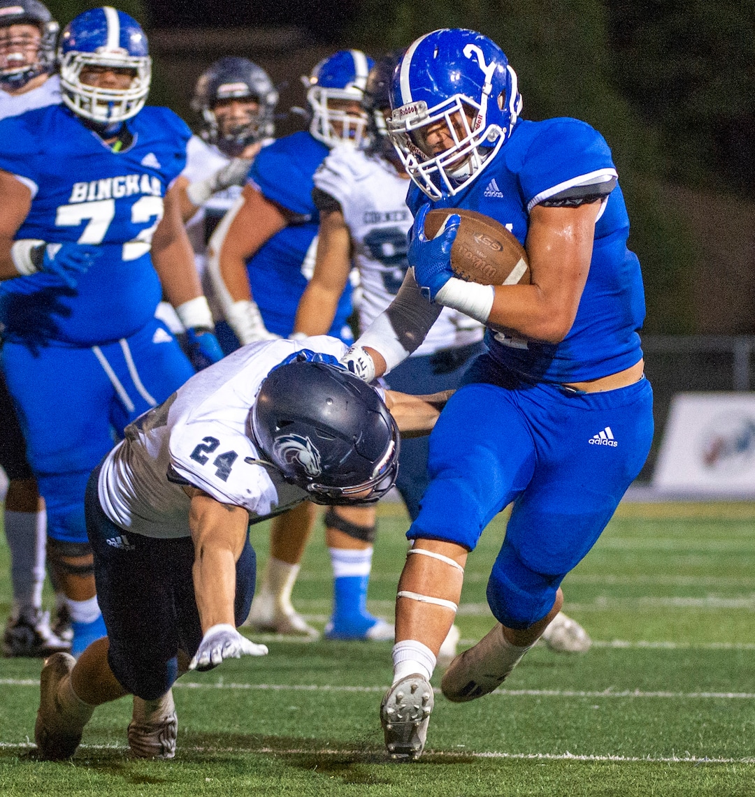 (Rick Egan  |  The Salt Lake Tribune)     Trevor Ogden grabs running back Saia Lomu as he  runs the ball for Bingham, in prep action between the Bingham Miners and the Corner Canyon Chargers, at Bingham High onFriday, Aug. 28, 2020.