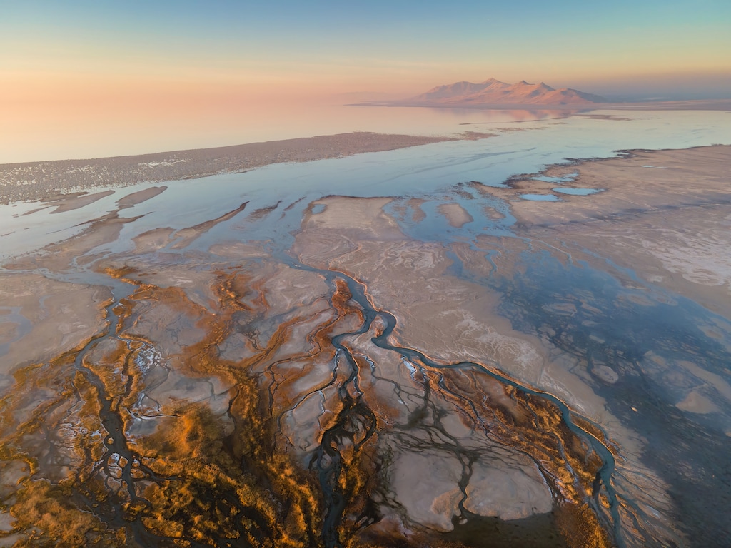 (Chris Carlson) Lee Creek Delta on the south shore of the Great Salt Lake, with Antelope Island in the distance. In the foreground, there are expose microbialites.