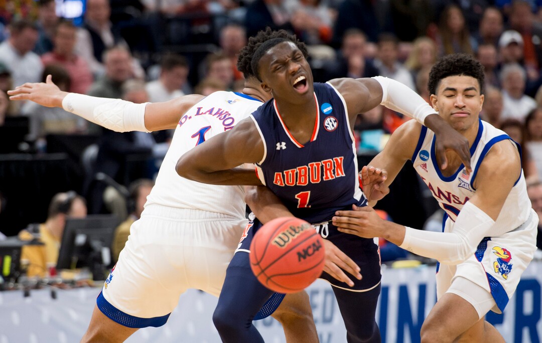 (Leah Hogsten  | The Salt Lake Tribune)  Auburn Tigers guard Jared Harper (1) gets double teamed by Kansas Jayhawks forward Dedric Lawson (1) and Kansas Jayhawks guard Quentin Grimes (5) as Auburn faces Kansas in the second round of the NCAA tournament in Salt Lake City on Saturday, March 23, 2019.