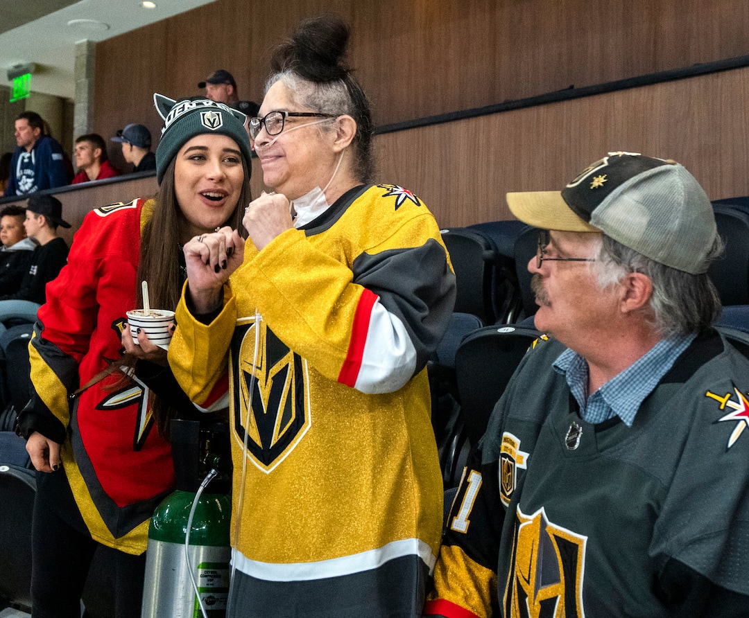 (Rick Egan | The Salt Lake Tribune) Madii Lewis smiles as her mother, Tina, dances to the music as they await the start of an NHL preseason game between the Los Angeles Kings and the Las Vegas Golden Knights, Thursday, Sept. 30, 2021. The game was Tina's first night out after coming home from the hospital from over six months of complications of COVID-19. The Lewis family are avid hockey fans and their favorite team is the Golden Knights.