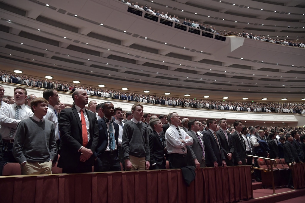 (Courtesy of LDS Church)  Mormon boys and men rise and sing the hymn "Rise Up, O Men of God."