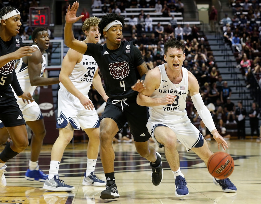 (Andrew Jansen | The Springfield News-Leader via AP) BYU's Alex Barcello dribbles the ball past Missouri State's Ja'Monta Black during an NCAA college basketball game, Saturday, Dec. 4, 2021, in Springfield, Mo.