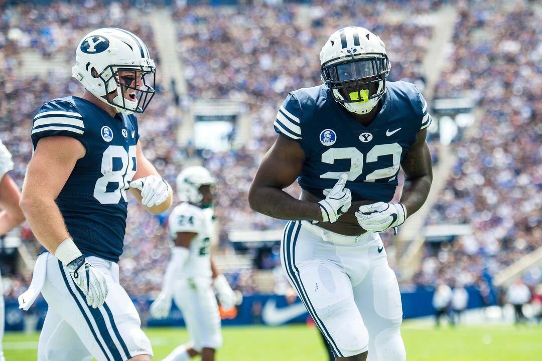 (Chris Detrick  |  The Salt Lake Tribune) Brigham Young Cougars running back Squally Canada (22) celebrates after scoring a touchdown during the game at LaVell Edwards Stadium Saturday, August 26, 2017. Brigham Young Cougars tight end Tanner Balderree (88) is at left.