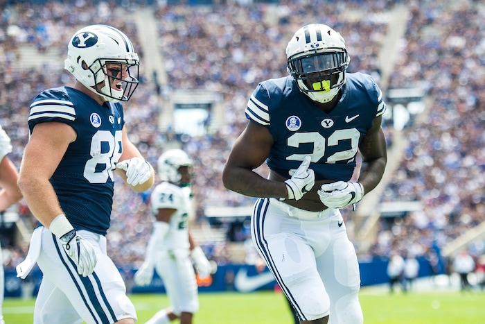 (Chris Detrick  |  The Salt Lake Tribune) Brigham Young Cougars running back Squally Canada (22) celebrates after scoring a touchdown during the game at LaVell Edwards Stadium Saturday, August 26, 2017. Brigham Young Cougars tight end Tanner Balderree (88) is at left.