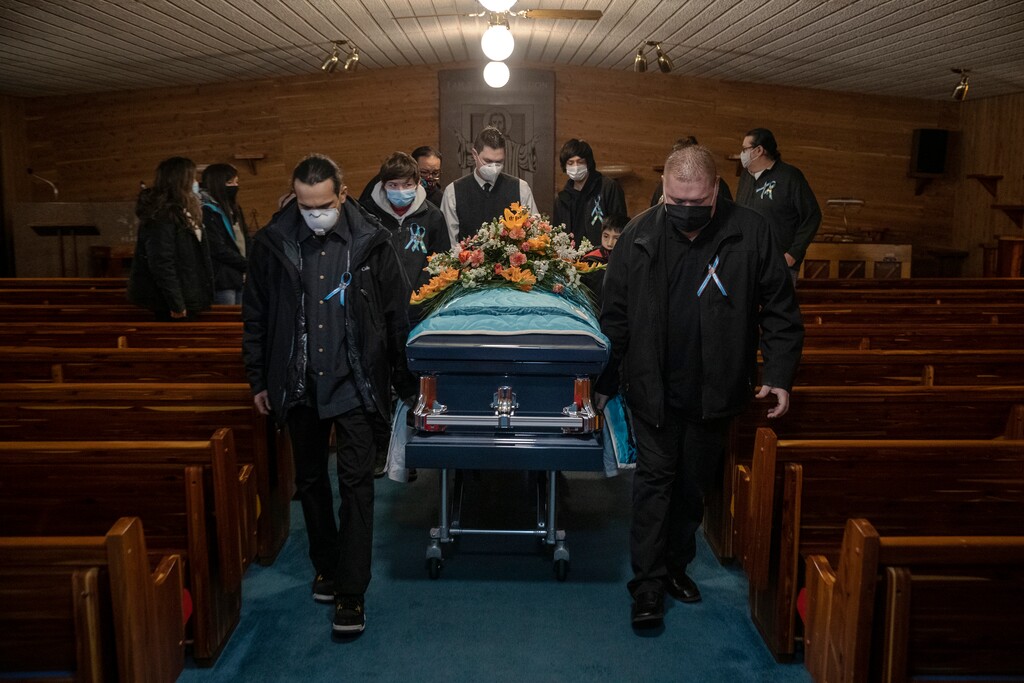 (Victor J. Blue | The New York Times) Pall bearers with the coffin of Jesse Taken Alive, a Lakota member of the Standing Rock Tribe who died of COVID-19, at Kesling Funeral Home in Mobridge, S.D., on Dec. 26, 2020. The coronavirus has killed American Indians at especially high rates, robbing tribes of precious bonds and repositories of language and tradition.