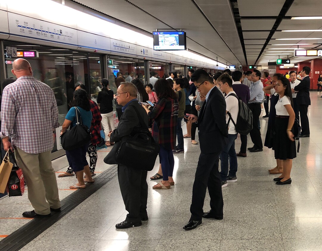 (Mike Stack  |  for The Salt Lake Tribune) LDS sister missionaries (far right) wait for train in central Hong Kong.